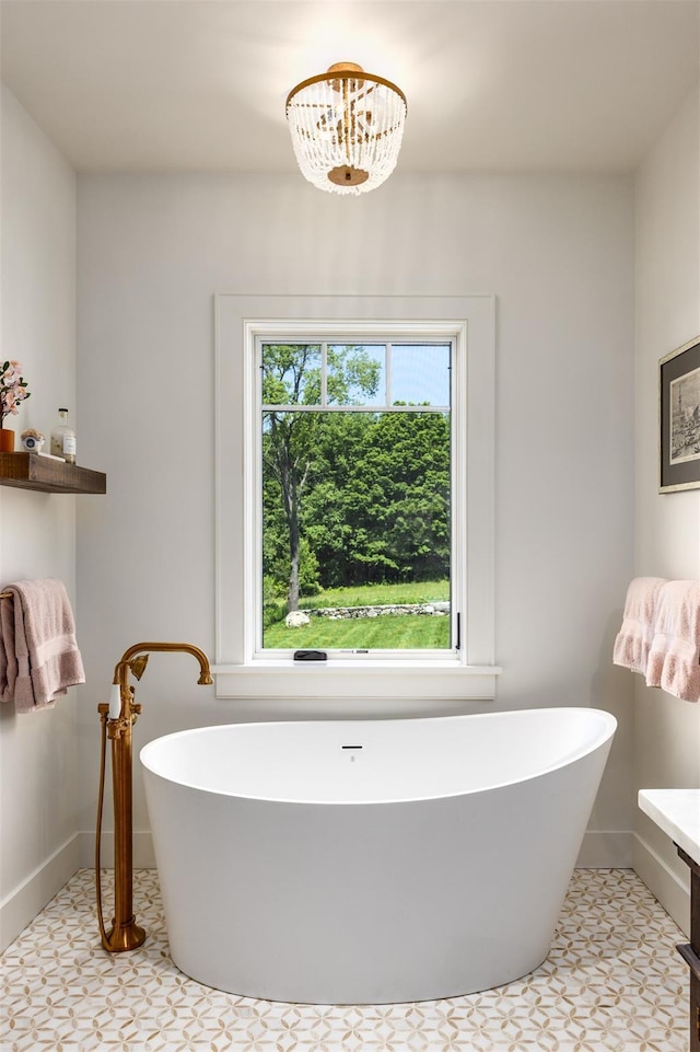 3585 Rte 82, Millbrook, NY 12545 - bathroom with a soaking tub, baseboards, and a chandelier