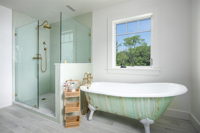 3585 Rte 82, Millbrook, NY 12545 - full bath featuring a soaking tub, walk in shower, wood finished floors, and baseboards