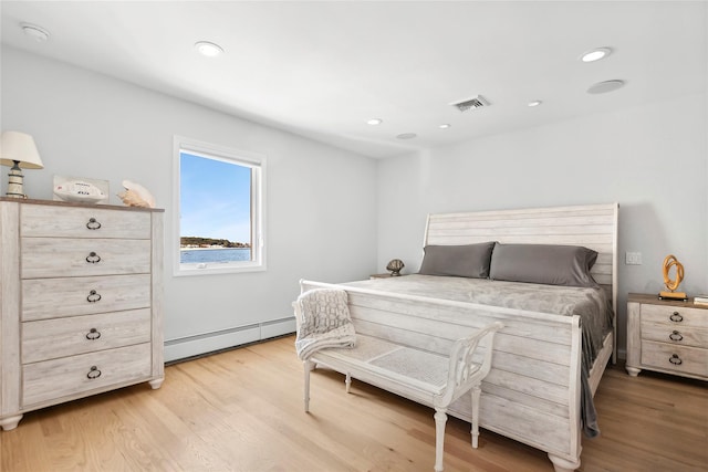 bedroom featuring a baseboard radiator, visible vents, light wood-type flooring, and recessed lighting