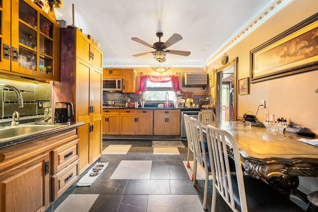 kitchen with stainless steel appliances, a ceiling fan, decorative backsplash, a sink, and dark countertops