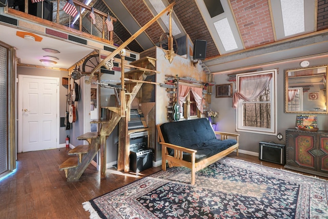 living area featuring high vaulted ceiling, baseboards, hardwood / wood-style flooring, and stairway