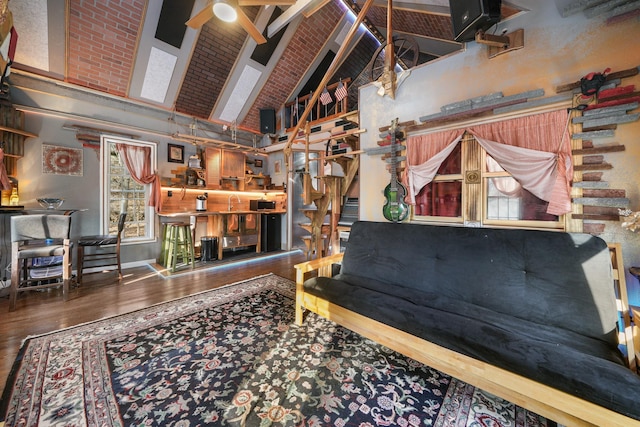 living room with high vaulted ceiling, ceiling fan, and wood finished floors
