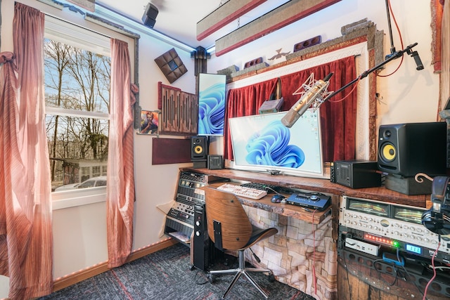 carpeted home office featuring baseboards