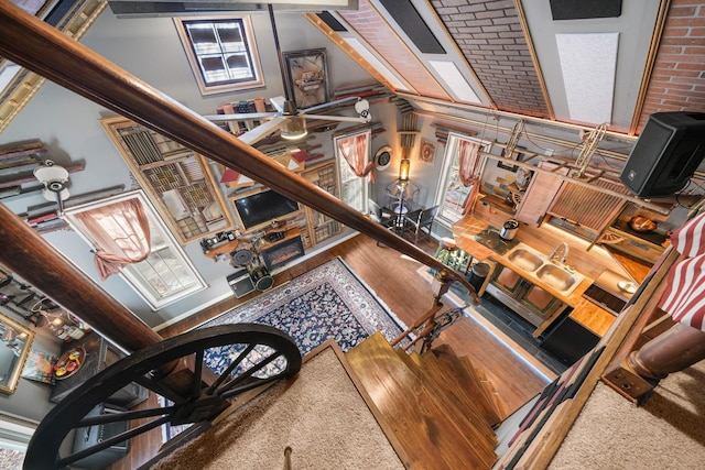 living area with wood finished floors and a towering ceiling