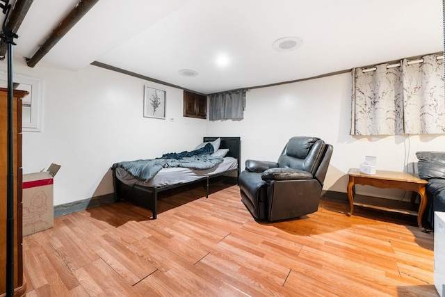 bedroom featuring light wood-style flooring and baseboards