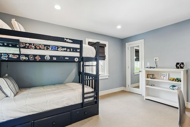 carpeted bedroom featuring baseboards and recessed lighting