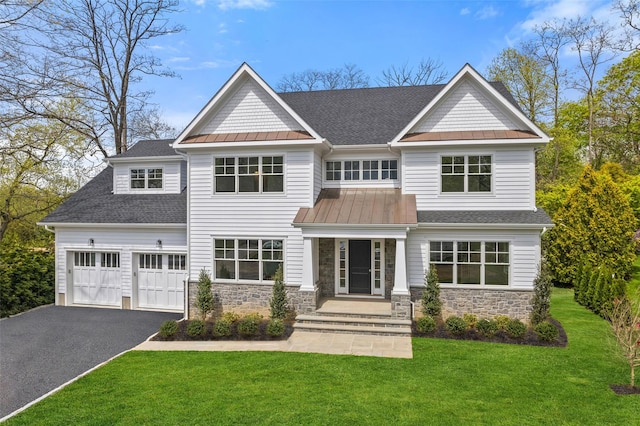 20 Carthage Ln, Scarsdale, NY 10583 - view of front facade featuring asphalt driveway, roof with shingles, a standing seam roof, and stone siding