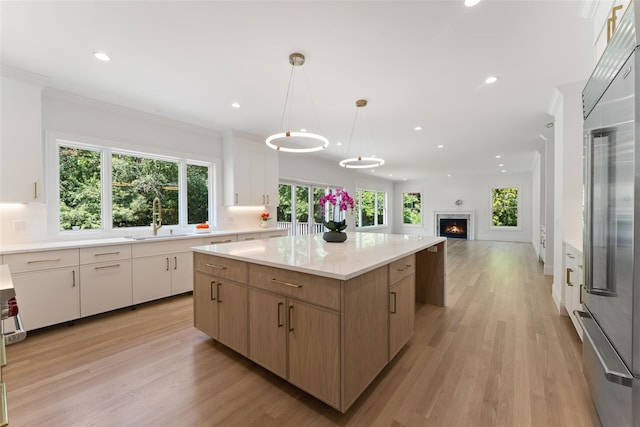 20 Carthage Ln, Scarsdale, NY 10583 - kitchen featuring a sink, a kitchen island, light wood finished floors, recessed lighting, and open floor plan