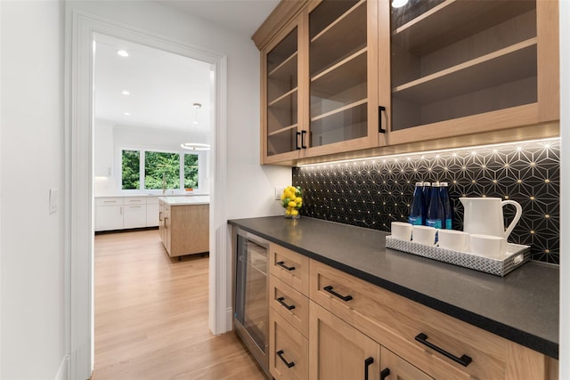 20 Carthage Ln, Scarsdale, NY 10583 - bar area featuring wine cooler, tasteful backsplash, light wood finished floors, and recessed lighting