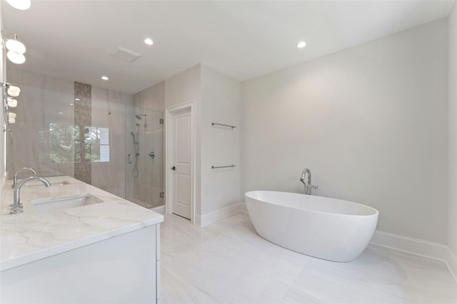 20 Carthage Ln, Scarsdale, NY 10583 - bathroom featuring a shower stall, a freestanding tub, baseboards, double vanity, and recessed lighting