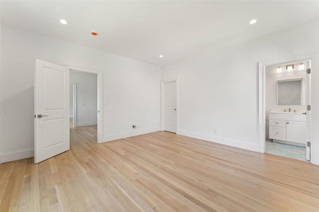 20 Carthage Ln, Scarsdale, NY 10583 - unfurnished bedroom with light wood-type flooring, baseboards, recessed lighting, ensuite bathroom, and a sink