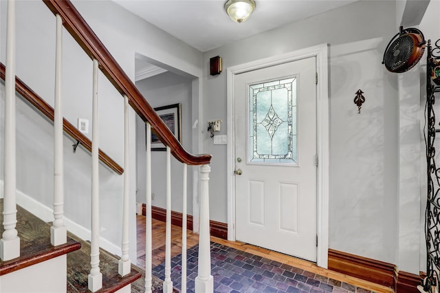 foyer with stairway and brick patterned floors