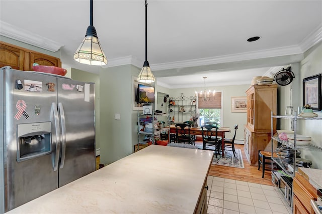 kitchen with stainless steel refrigerator with ice dispenser, a chandelier, light tile patterned floors, crown molding, and decorative light fixtures