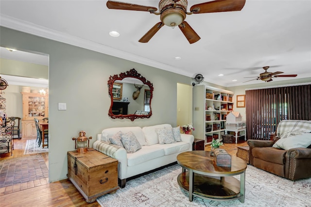 living room with ceiling fan, ornamental molding, recessed lighting, and a chandelier