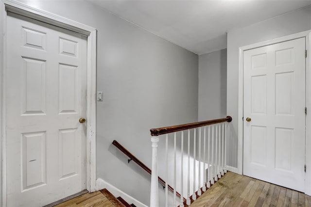 stairs with hardwood / wood-style flooring and baseboards