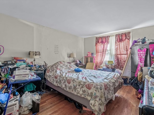 bedroom featuring wood finished floors