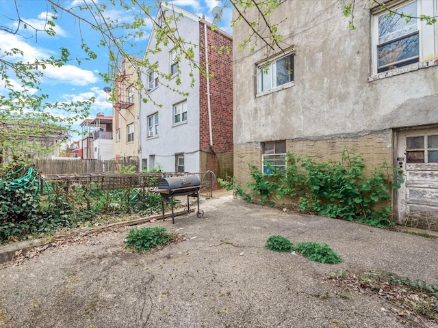 view of home's community with a patio and fence