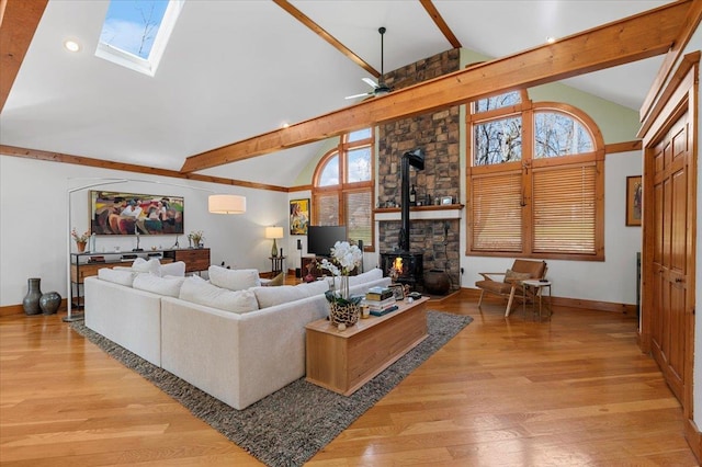 58 Big Island Rd, Warwick, NY 10990 - living room with a wood stove, beam ceiling, light wood-type flooring, a skylight, and ceiling fan