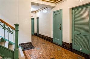 interior space with crown molding and stairway