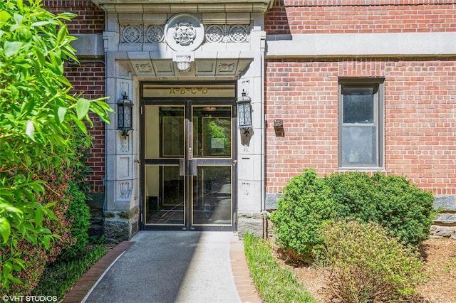 property entrance featuring brick siding