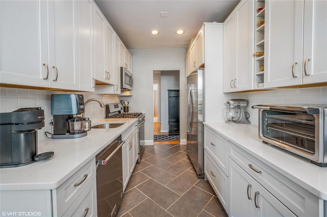 kitchen with a toaster, appliances with stainless steel finishes, decorative backsplash, and recessed lighting