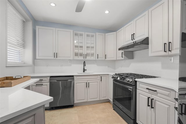 325 King St Unit 4D, Port Chester, NY 10573 - kitchen featuring stainless steel appliances, under cabinet range hood, backsplash, light countertops, and light tile patterned floors