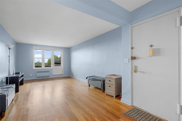 325 King St Unit 4D, Port Chester, NY 10573 - foyer entrance with radiator and light wood-style floors