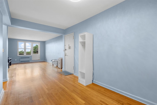 325 King St Unit 4D, Port Chester, NY 10573 - empty room with radiator heating unit and light wood-style floors