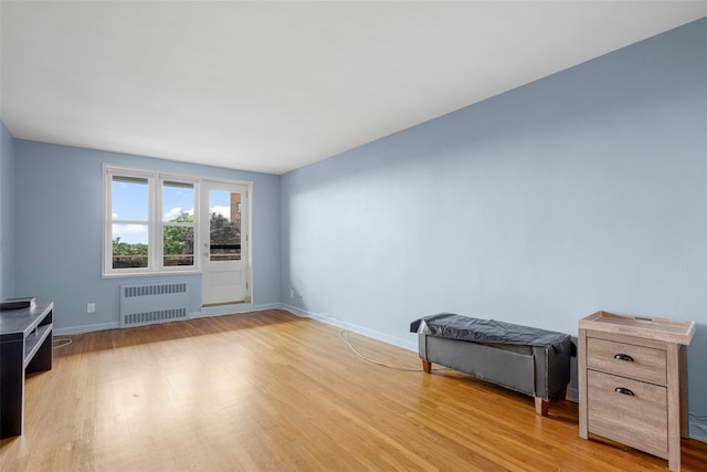 325 King St Unit 4D, Port Chester, NY 10573 - unfurnished living room with radiator heating unit and light wood-style flooring