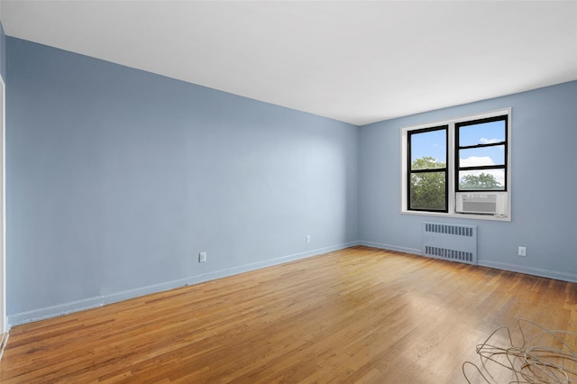 325 King St Unit 4D, Port Chester, NY 10573 - spare room featuring radiator heating unit and light wood-style flooring