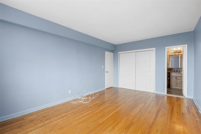 325 King St Unit 4D, Port Chester, NY 10573 - unfurnished bedroom featuring a closet, light wood-style floors, and ensuite bathroom
