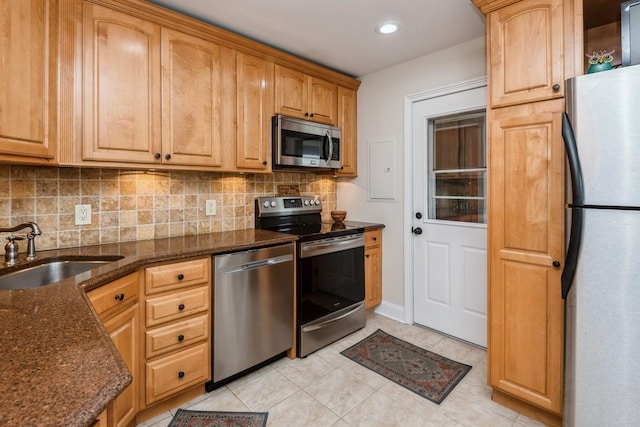 32 Peony Rd, Levittown, NY 11756 - kitchen with stainless steel appliances, a sink, light tile patterned floors, tasteful backsplash, and recessed lighting