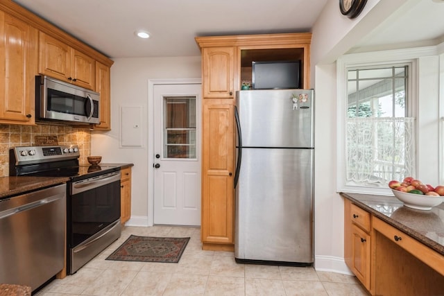 32 Peony Rd, Levittown, NY 11756 - kitchen featuring appliances with stainless steel finishes, baseboards, backsplash, light tile patterned flooring, and recessed lighting
