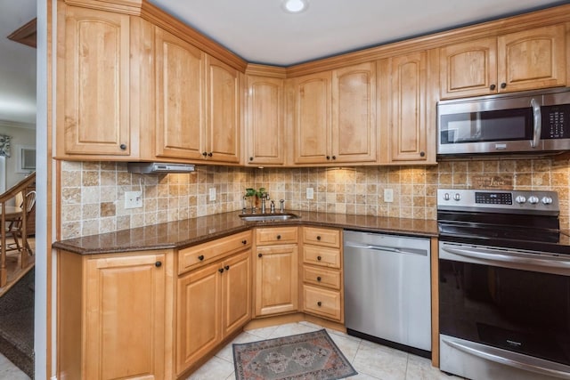 32 Peony Rd, Levittown, NY 11756 - kitchen with stainless steel appliances, dark stone countertops, decorative backsplash, light tile patterned flooring, and recessed lighting