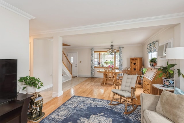 32 Peony Rd, Levittown, NY 11756 - living area featuring stairway, wood finished floors, ornamental molding, a chandelier, and baseboards