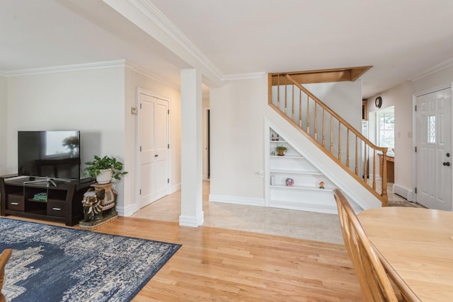 32 Peony Rd, Levittown, NY 11756 - foyer featuring stairway, wood finished floors, ornamental molding, and baseboards