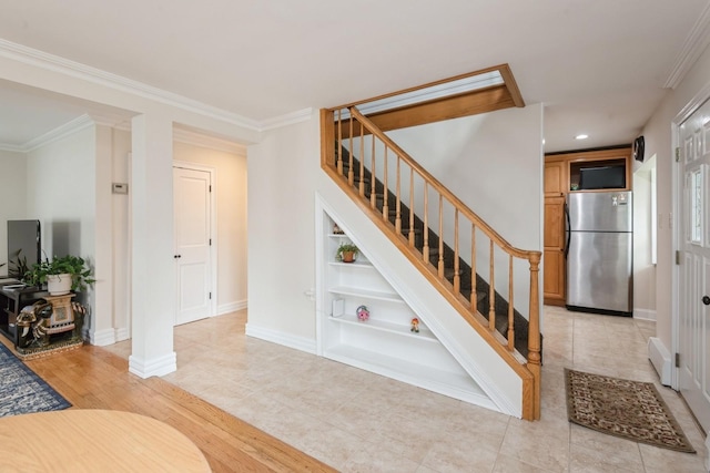 32 Peony Rd, Levittown, NY 11756 - stairs featuring built in shelves, baseboards, crown molding, wood finished floors, and recessed lighting
