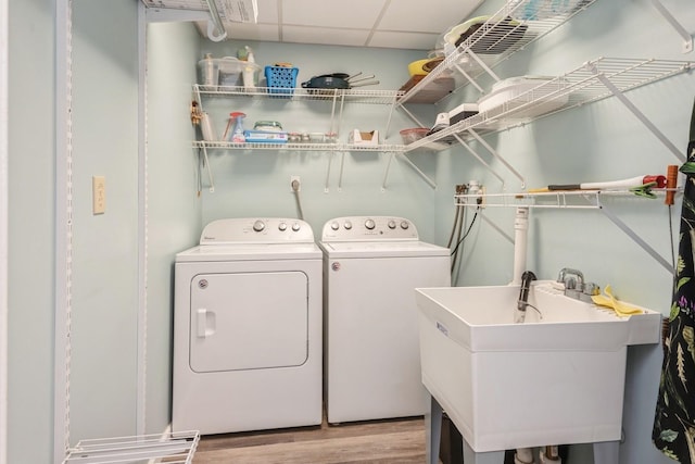 32 Peony Rd, Levittown, NY 11756 - laundry room with washer and clothes dryer and light wood-type flooring