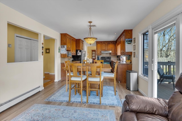 dining space featuring visible vents, baseboards, recessed lighting, light wood-type flooring, and a baseboard radiator