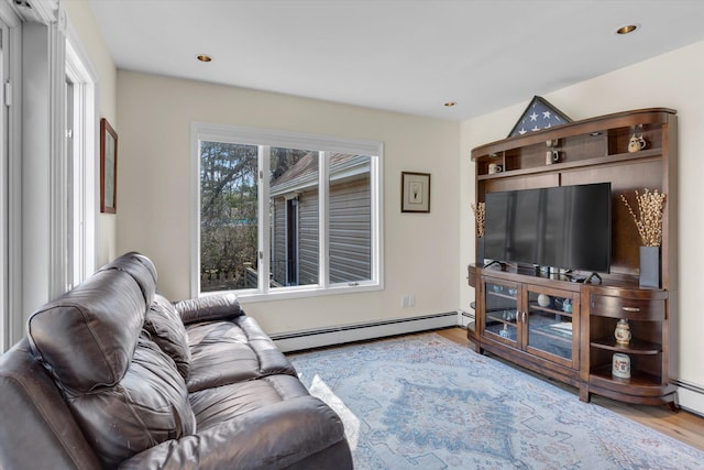 living area featuring a baseboard radiator, recessed lighting, and wood finished floors