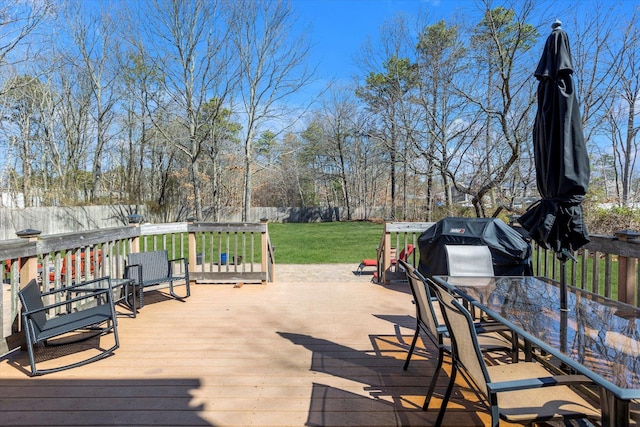deck with a yard, a fenced backyard, and outdoor dining space