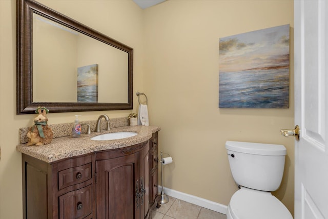 bathroom featuring toilet, baseboards, tile patterned floors, and vanity