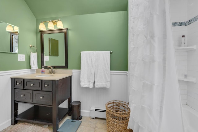 full bathroom with vanity, shower / tub combo with curtain, wainscoting, and a baseboard heating unit