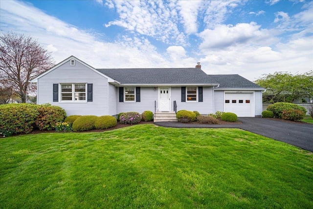 single story home featuring a chimney, a front yard, aphalt driveway, an attached garage, and a shingled roof