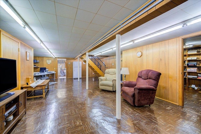 interior space featuring stairs and wooden walls