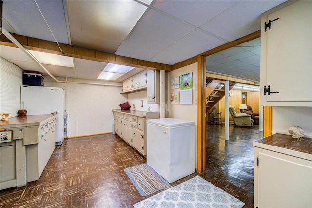 laundry room with baseboards
