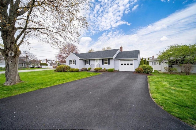 ranch-style home featuring an attached garage, a front lawn, aphalt driveway, and a chimney