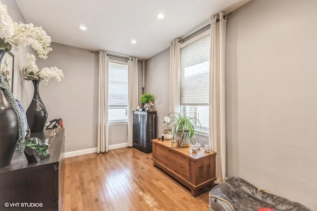 sitting room with baseboards, light wood-type flooring, and recessed lighting