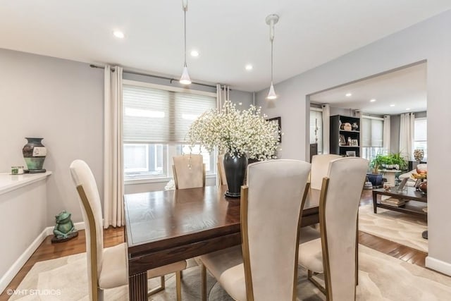 dining room with recessed lighting, baseboards, and light wood-style floors