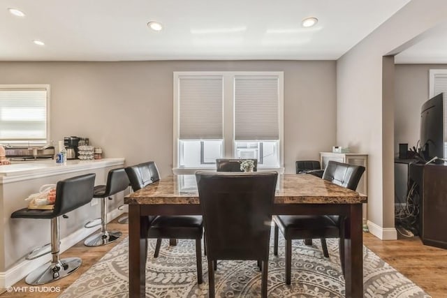 dining space with light wood-style floors, recessed lighting, and baseboards
